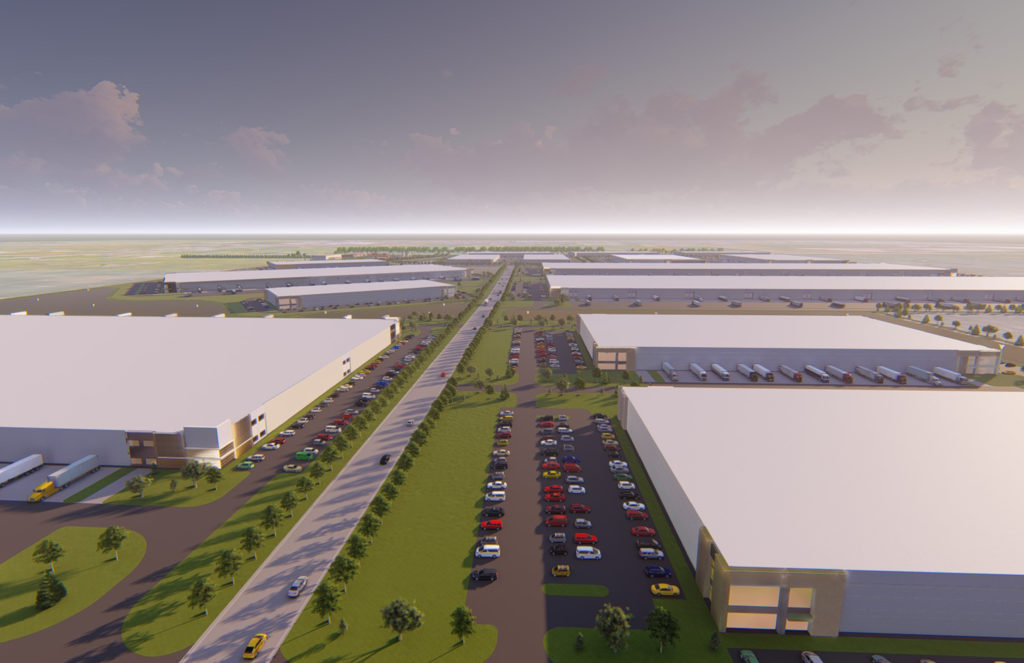 Aerial view of a large industrial complex with multiple white-roofed warehouse buildings, rows of parked cars, trucks at loading docks, and landscaped green areas under a partly cloudy sky.